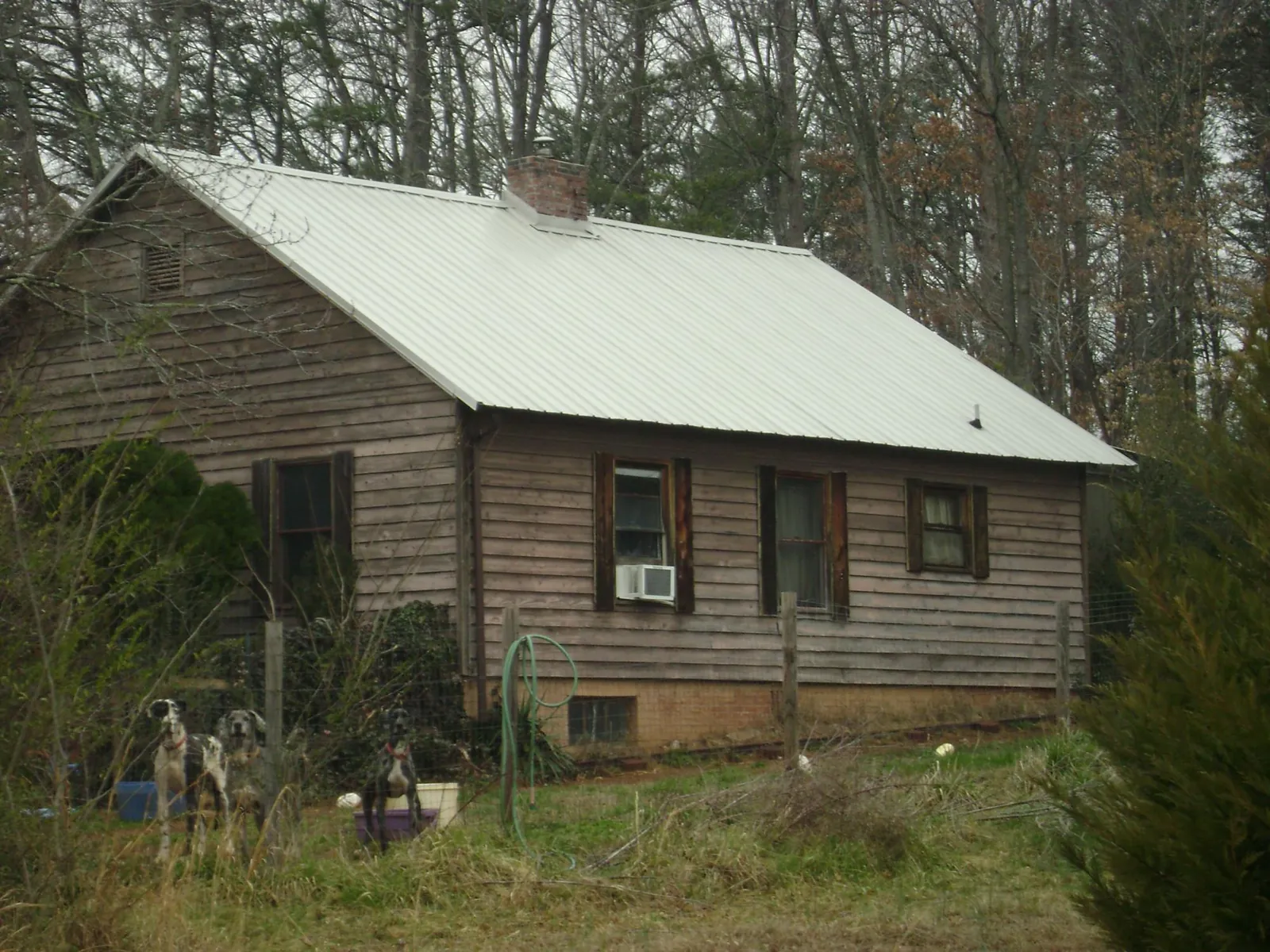 White metal roof on an old wood sided farmhouse, from a Metal Roof Installation job in Brockway
